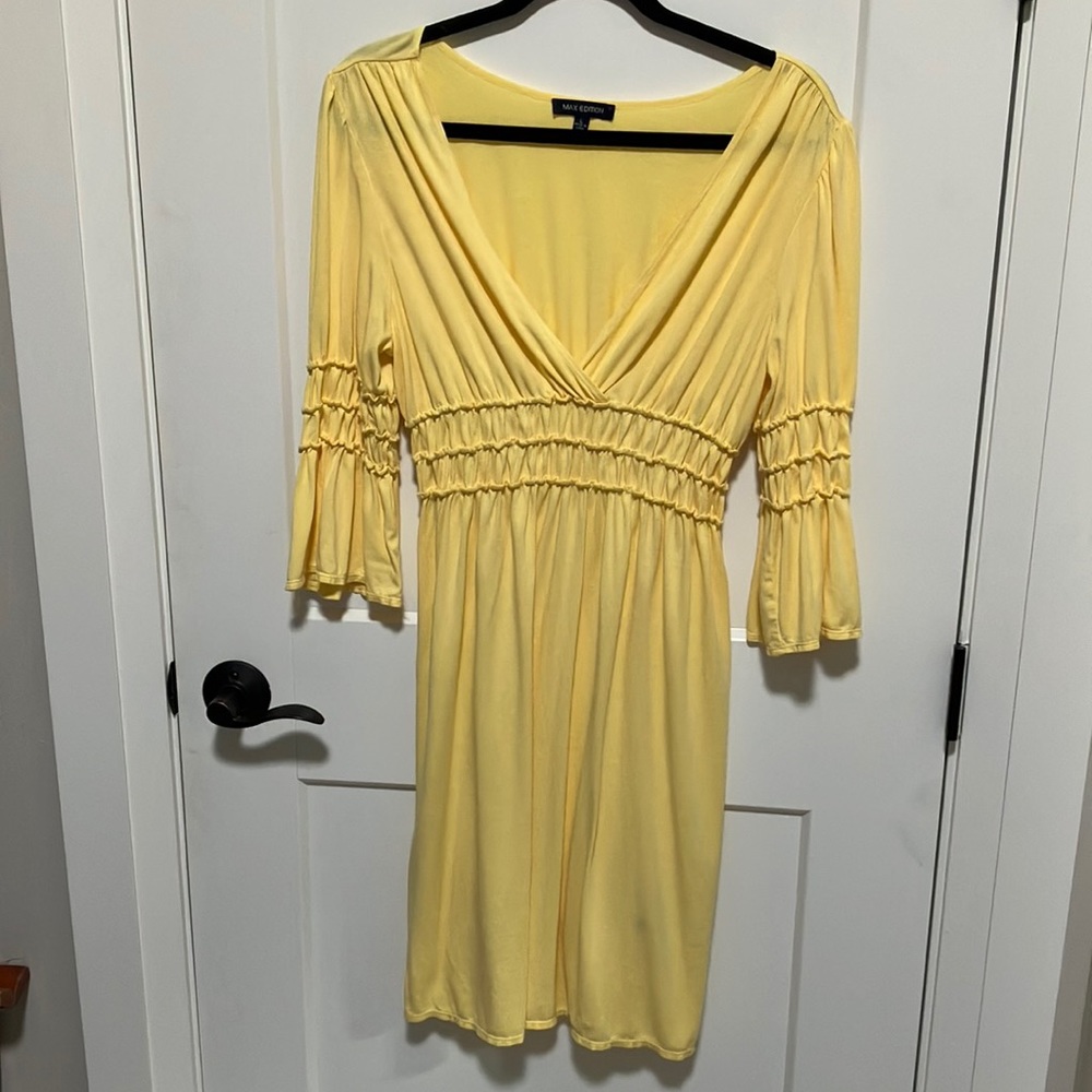 Yellow with ruffled sleeves. Deep V neck. Feminine, Soft and flowing.